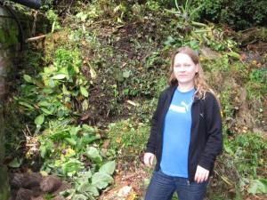 Lead scientist of the study, Dr. Carola Petersen, in front of an enormous compost heap - one of the C. elegans collection sites