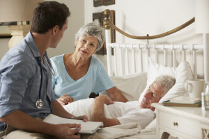 Patient in bed with doctor and wife present