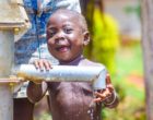 Young_african_child_playing_with_water