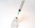 Needle syringe with a vaccine bottle. Credit NIH