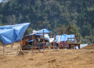Land clearing for road construction project in northern Lao PDR: temporary worker shelters near to forested areas