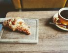 pastry-bread-beside-brown-ceramic-teacup-with-coffee-3172623