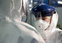 Checking_Personal_Protective_Equipment_(PPE)_in_the_fight_against_Ebola_(15650272810)