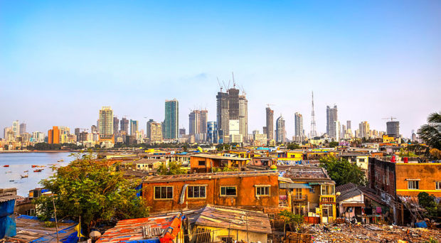 Mumbai cityscape with informal settlements in the foreground and skyscrapers behind