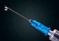 Medical syringe with a needle at the end of the drop
