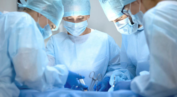 Operating team performing surgery in a modern hospital