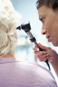 Doctor examining a patient's ear