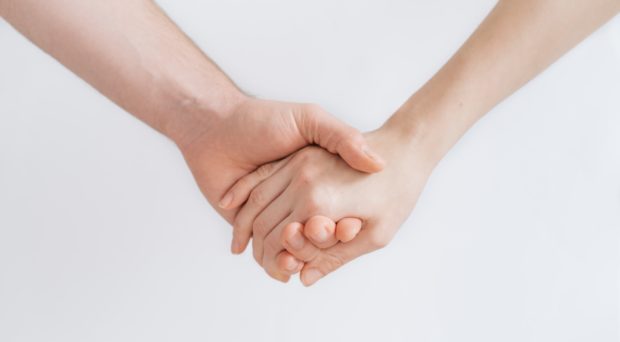 Two people holding hands