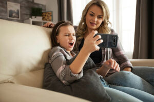 Little girl exclaiming to her mother about what they are watching on a smart phone